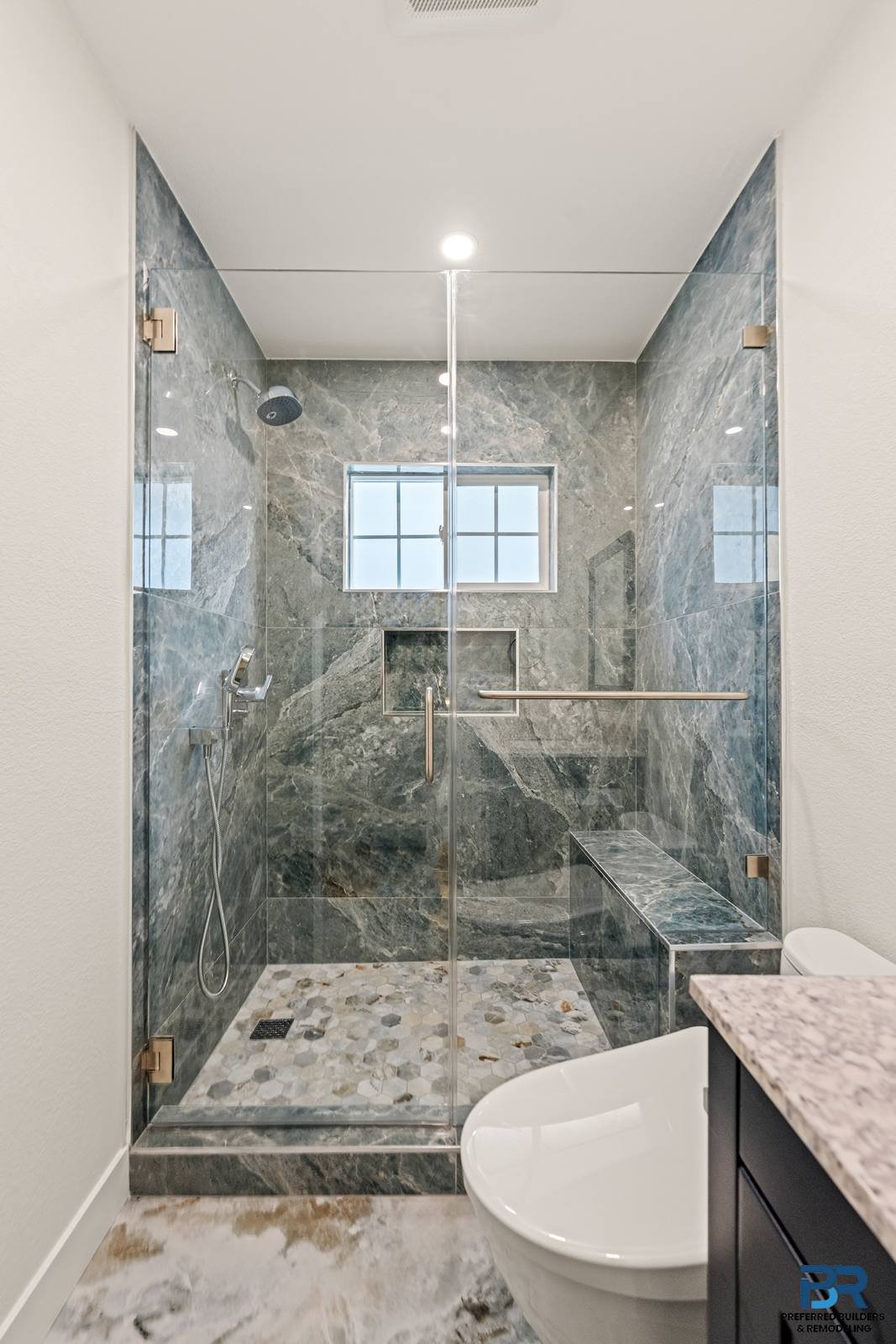 Stone-look tile shower with a niche in a remodeled San Jose bathroom