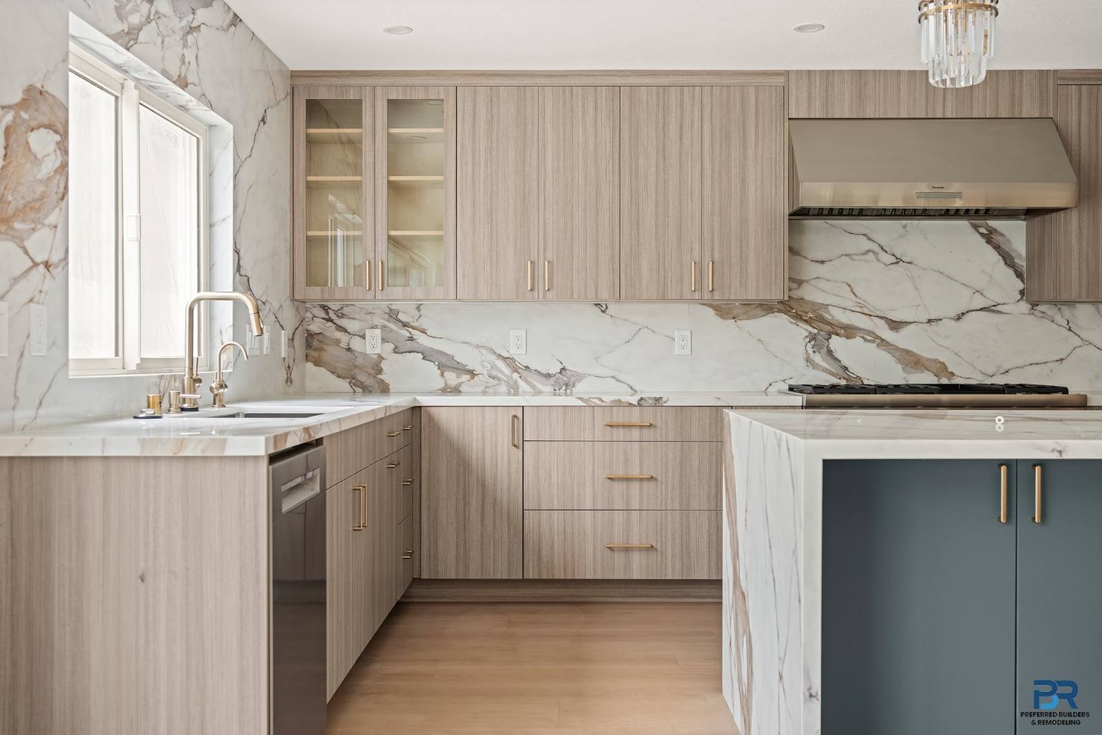 Remodeled kitchen with a window over the sink and marble countertops in San Jose