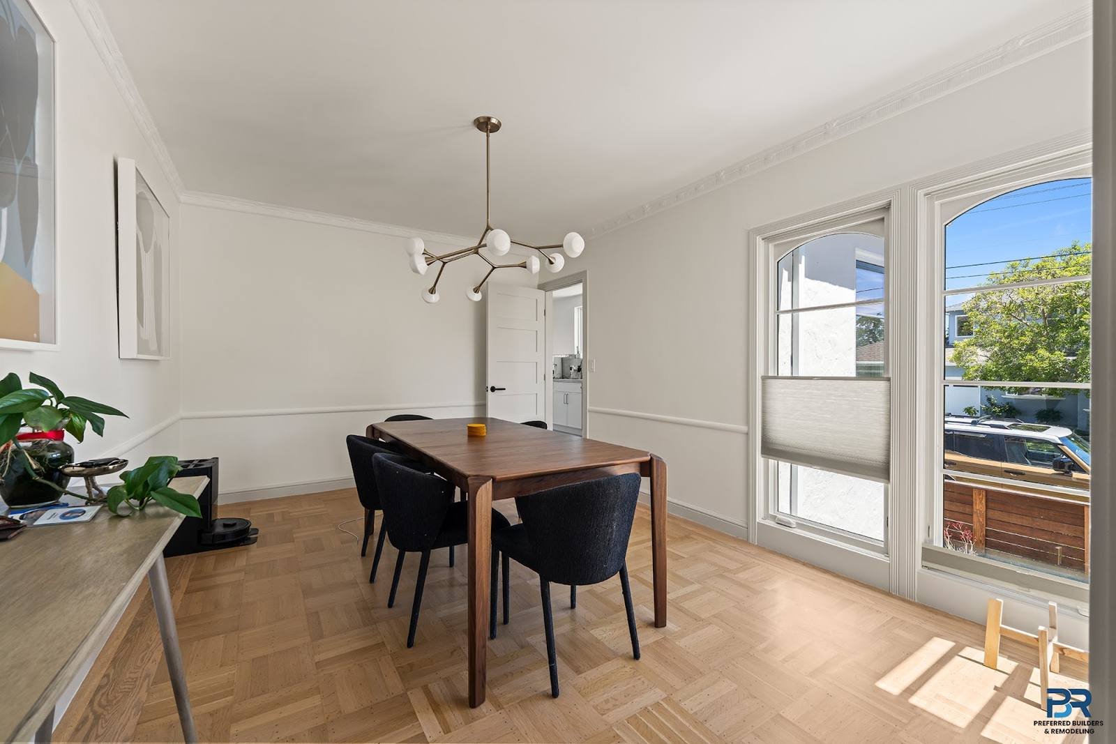 Dining area with a pendant light and glass doors in a San Carlos whole-house remodel